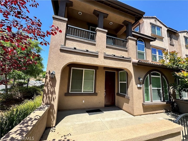 view of front of property with a balcony