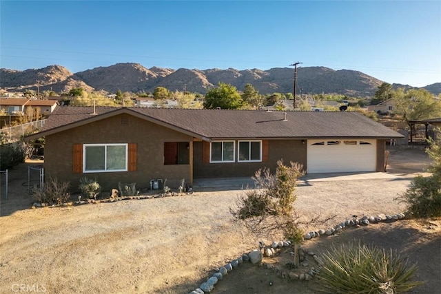 ranch-style house featuring a mountain view and a garage