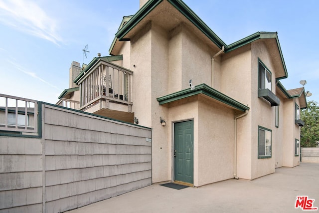 rear view of property with a balcony