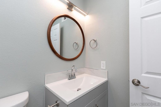 bathroom featuring toilet and vanity