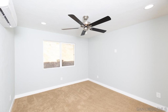 carpeted spare room featuring ceiling fan and a wall mounted AC