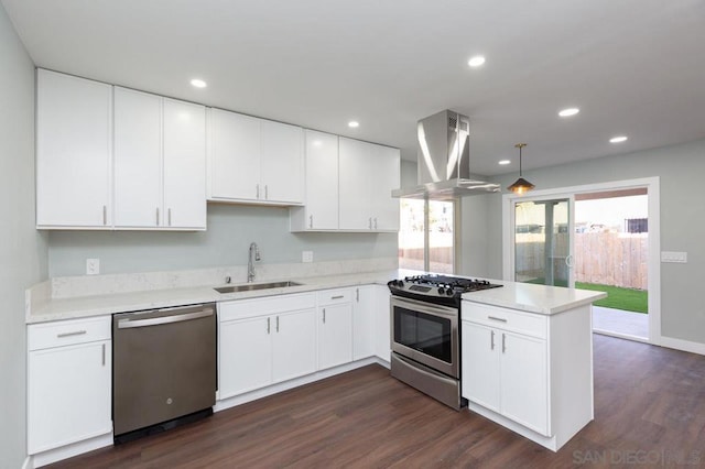 kitchen with white cabinetry, island range hood, kitchen peninsula, appliances with stainless steel finishes, and sink