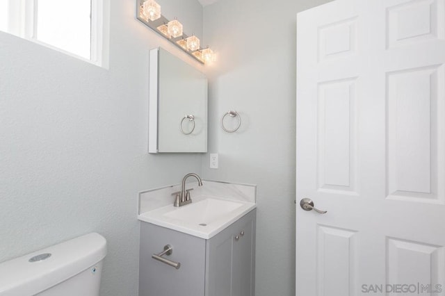 bathroom featuring toilet and vanity