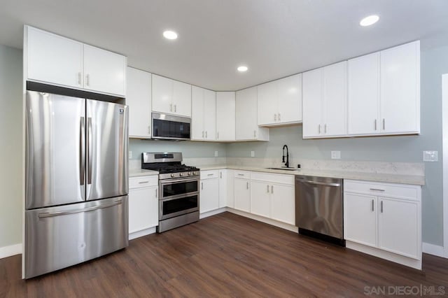 kitchen featuring stainless steel appliances and white cabinetry