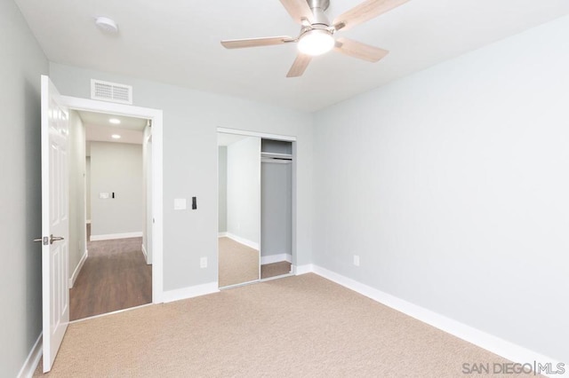 unfurnished bedroom featuring ceiling fan, carpet, and a closet