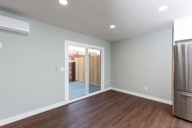 interior space with a wall mounted AC and dark hardwood / wood-style floors