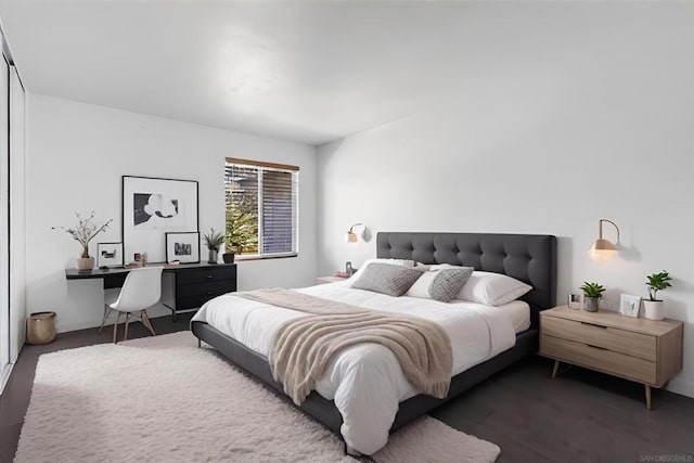 bedroom with dark wood-type flooring