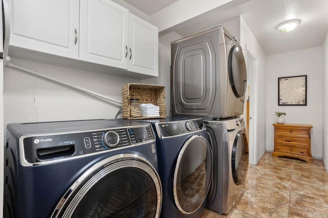 laundry room featuring cabinets and washing machine and clothes dryer