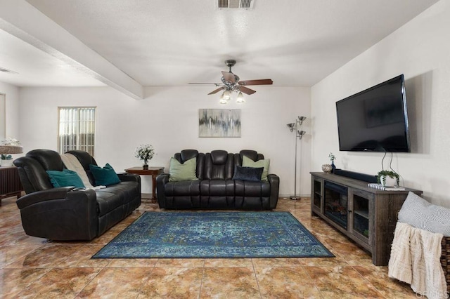 living room with ceiling fan and beamed ceiling