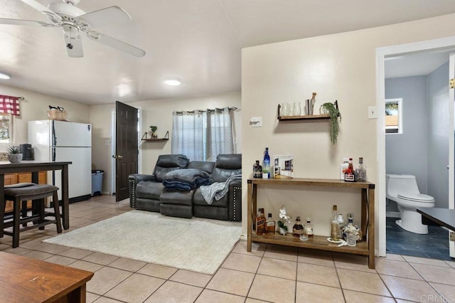 tiled living room with ceiling fan