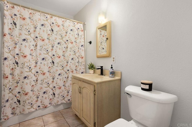 bathroom featuring toilet, tile patterned flooring, and vanity