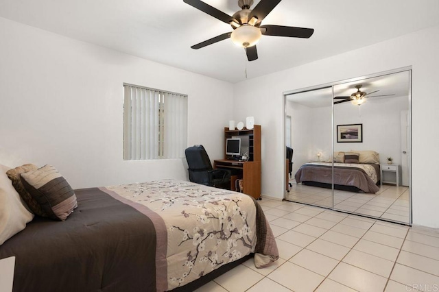 tiled bedroom featuring ceiling fan and a closet