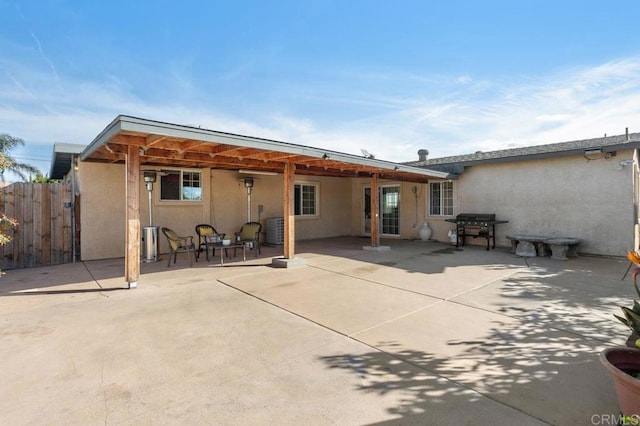 rear view of property featuring central AC and a patio