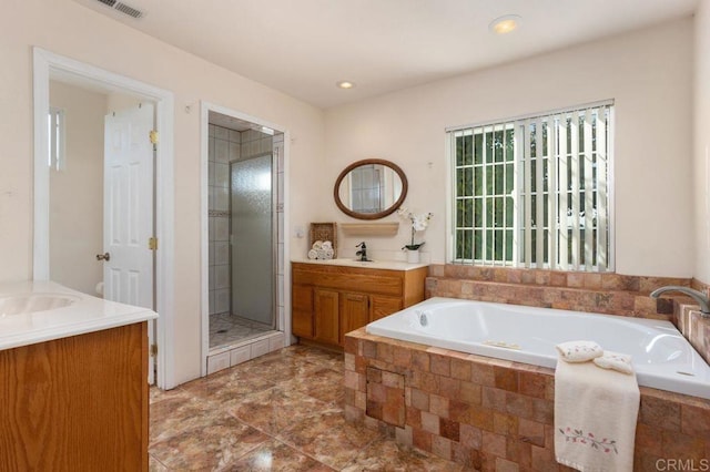 bathroom featuring independent shower and bath and vanity