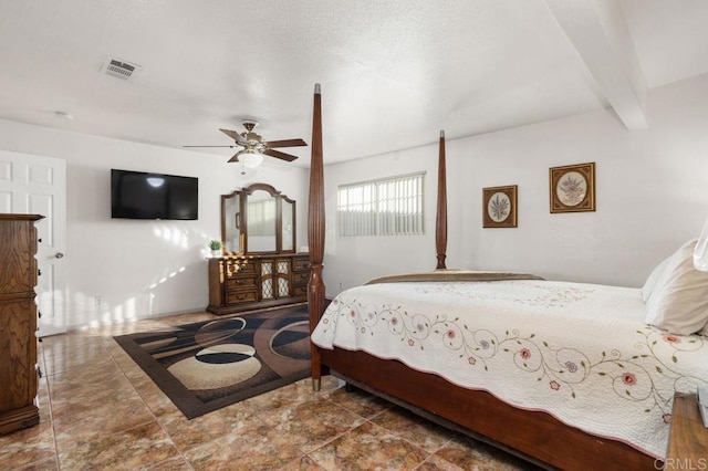 bedroom with ceiling fan and beam ceiling