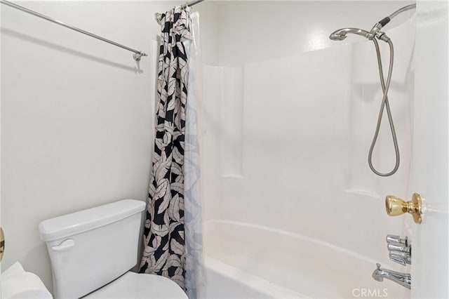 bathroom with toilet and shower / bath combo