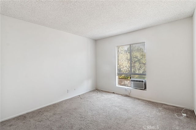 empty room with a textured ceiling and carpet floors