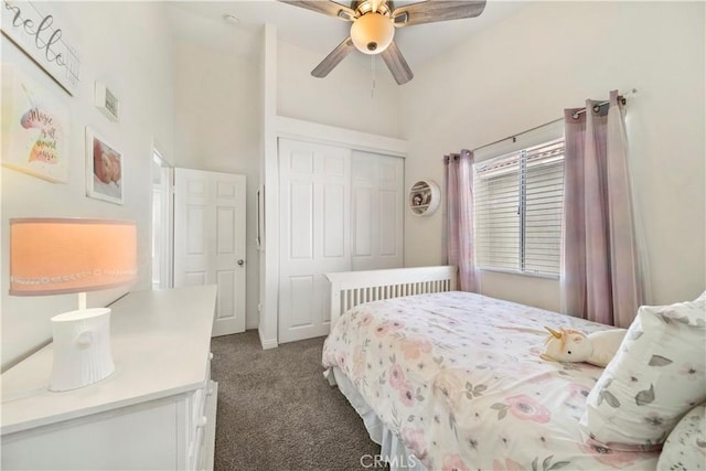 carpeted bedroom with ceiling fan, high vaulted ceiling, and a closet