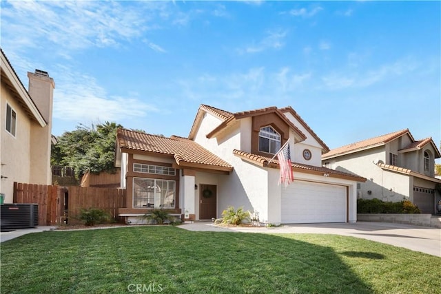 mediterranean / spanish house with central air condition unit, a front lawn, and a garage