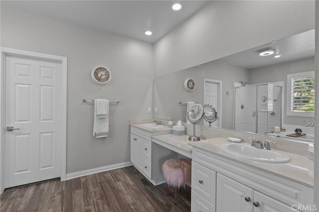 bathroom featuring walk in shower, vanity, and hardwood / wood-style floors