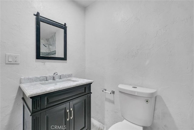 bathroom featuring toilet and vanity