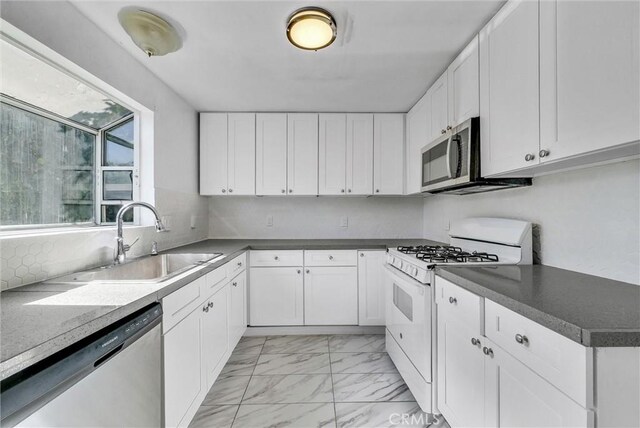 kitchen with white cabinets, sink, and stainless steel appliances