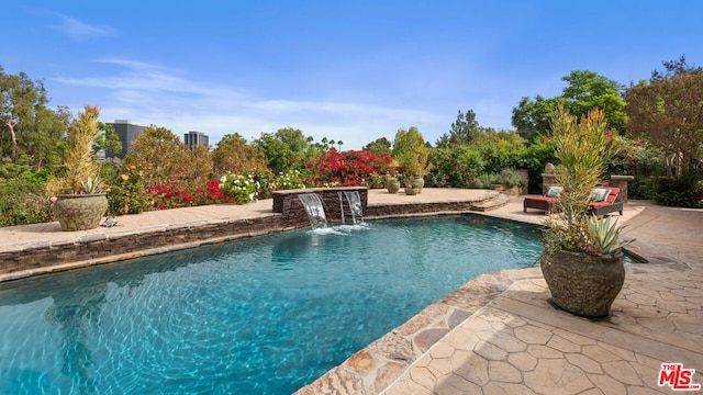 view of pool with pool water feature and a patio area