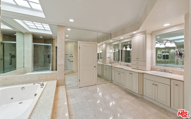 bathroom with a skylight, ornamental molding, separate shower and tub, and vanity