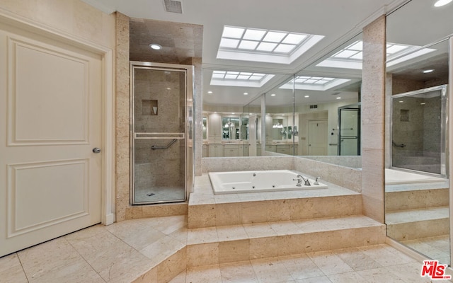 bathroom featuring a skylight and shower with separate bathtub