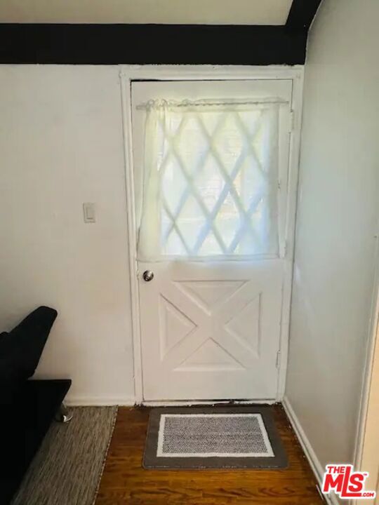 doorway to outside with dark wood-type flooring