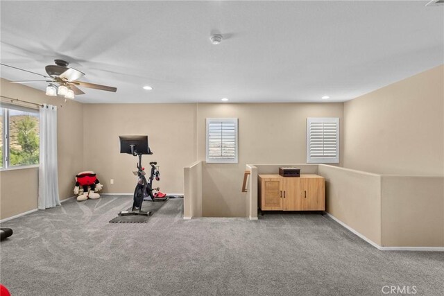 workout area with ceiling fan and carpet flooring