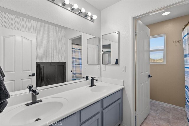 bathroom featuring tile patterned flooring and vanity