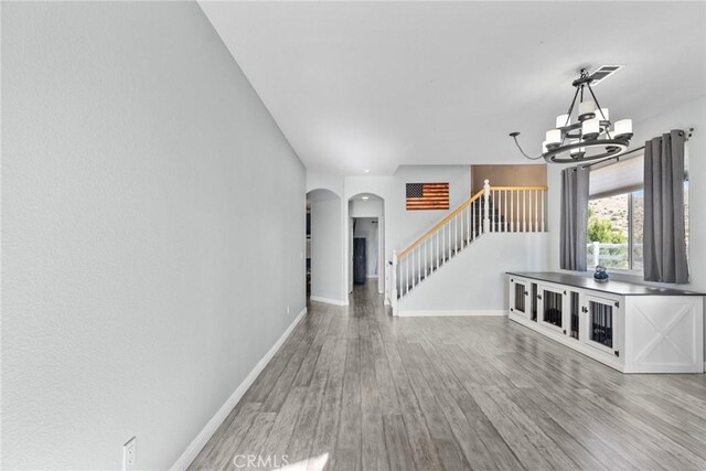 interior space featuring light wood-type flooring and a chandelier