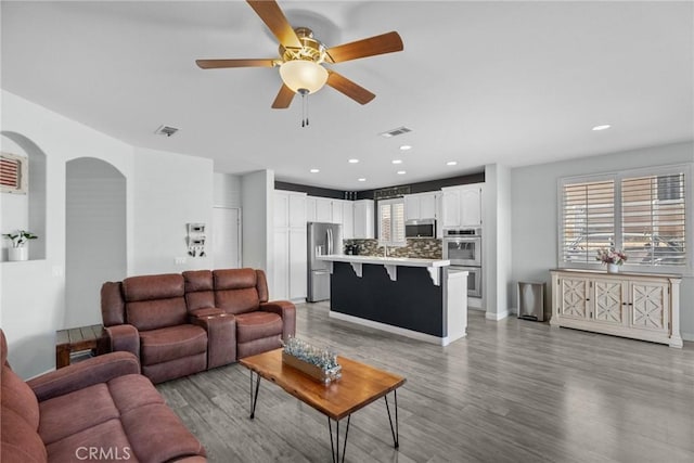 living room featuring ceiling fan and light wood-type flooring