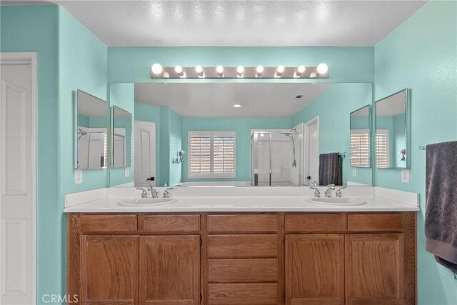 bathroom featuring walk in shower and vanity