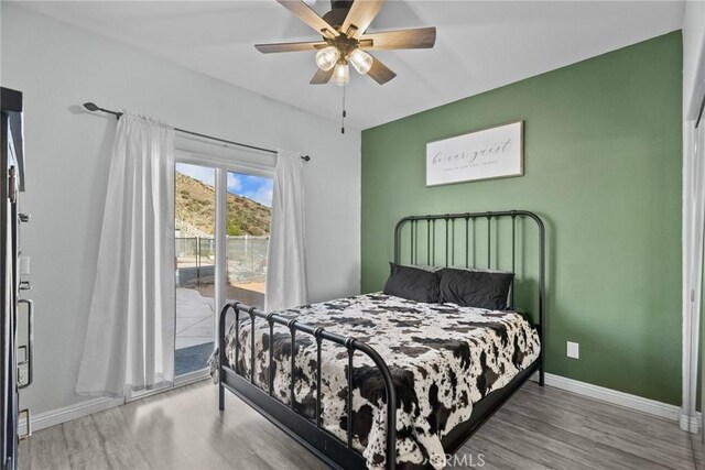 bedroom featuring ceiling fan, hardwood / wood-style floors, and access to outside