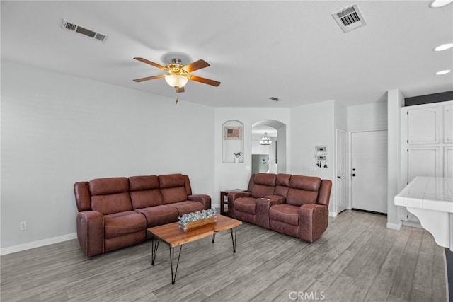 living room with ceiling fan and light hardwood / wood-style flooring