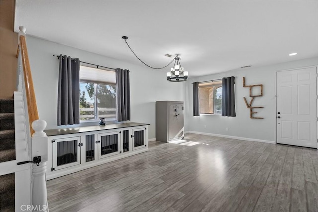 living room with wood-type flooring and an inviting chandelier