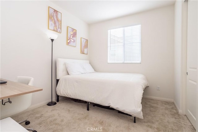 bedroom featuring light carpet