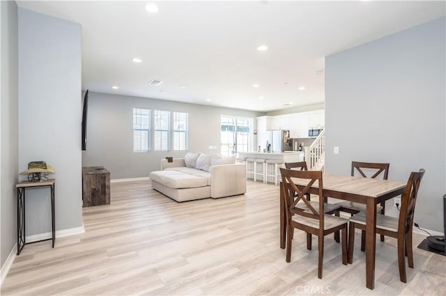 dining area with light hardwood / wood-style floors