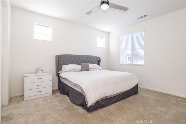 bedroom featuring ceiling fan and light colored carpet