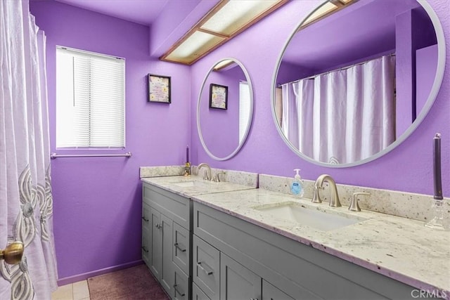 bathroom featuring a healthy amount of sunlight, tile patterned floors, and vanity