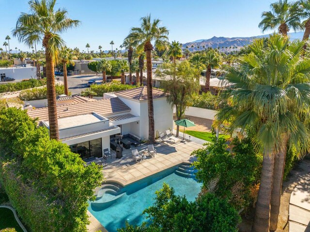 view of swimming pool with a patio area and a mountain view