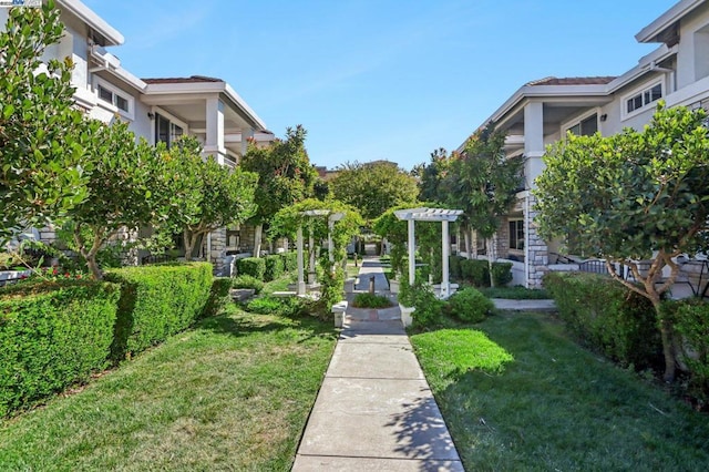 view of property's community with a lawn