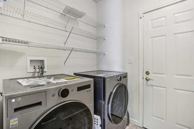 clothes washing area featuring washer and clothes dryer