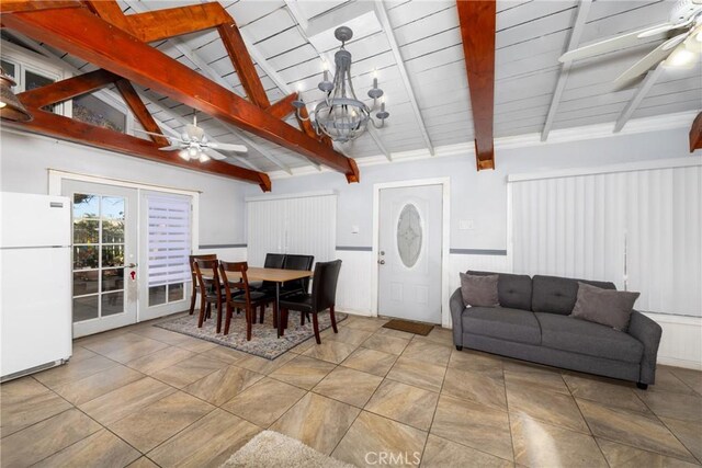 dining space with ceiling fan with notable chandelier and lofted ceiling with beams