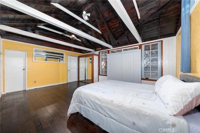 bedroom featuring lofted ceiling with beams and dark hardwood / wood-style flooring