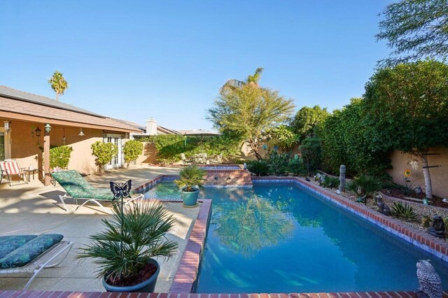 view of swimming pool with a patio area