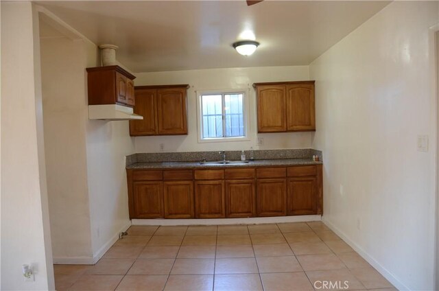 kitchen featuring sink and light tile patterned floors