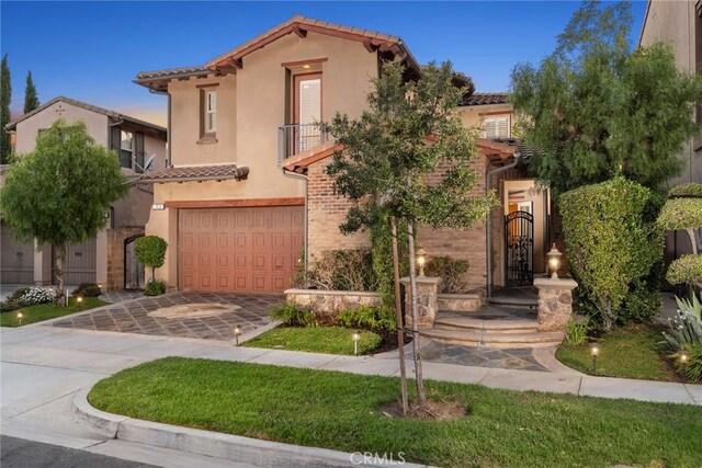 mediterranean / spanish home with a garage